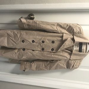 Tan trench coat with puffed shoulders